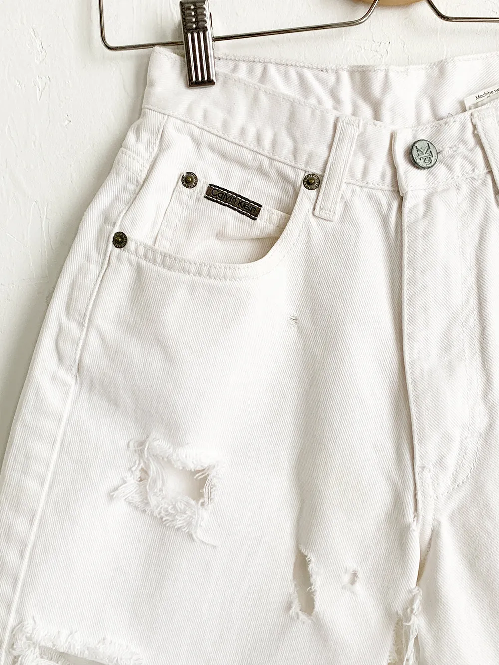 CK Distressed White Cut Offs